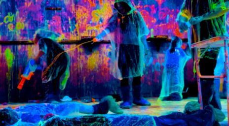 Group of people shooting paint at each other