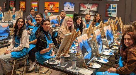 A group of people painting at Pinot’s Palette