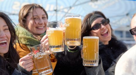 Happy people cheers-ing with Steam Whistle beer