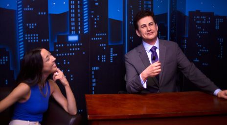 Girl admiring and sitting next to a Jimmy Kimmel wax figure