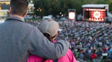 Man with arm around woman starting at Main Stage in the distance