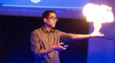 Man giving a presentation and a fireball erupting from his hand
