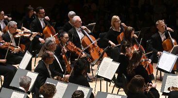 Toronto Symphony Orchestra playing their instruments on stage during a concert